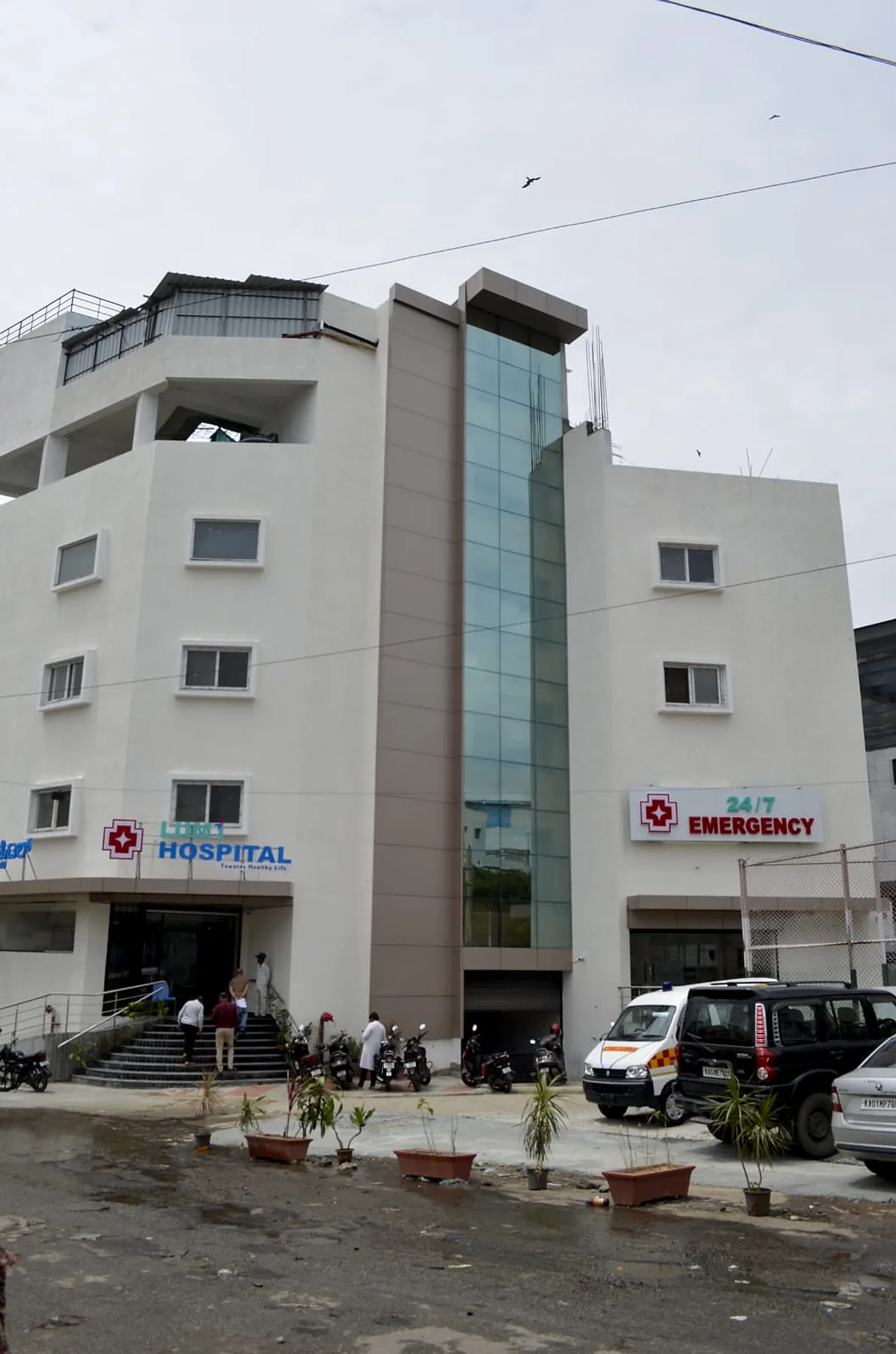 Lumi Hospital building with its glass stairwell and ambulance bay